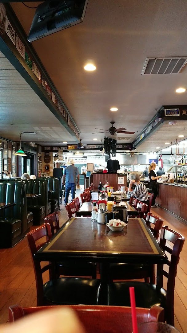 Counter seating beside a busy breakfast grill.